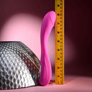 Evolved Sugar Rush G-Spot Vibrator in pink, displayed upright next to a ruler for size reference, showcasing arched shaft and textured head.