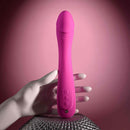 Pink Evolved Sugar Rush G-Spot Vibrator with multi-speed settings held by a white mannequin hand on a textured surface