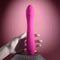 Pink Evolved Sugar Rush G-Spot Vibrator with multi-speed settings held by a white mannequin hand on a textured surface