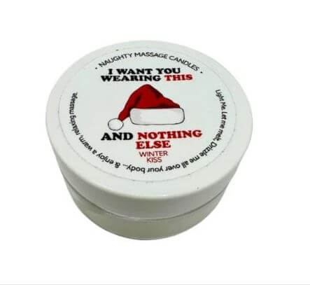 Kama Sutra Holiday Mini Massage Candle with "I Want You Wearing This" label in festive design, Winter Kiss scent.