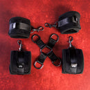 SEI MIO Hogtied and Satisfied Hog Tie & Cuff Set displayed on a red background, featuring padded cuffs and connectors.