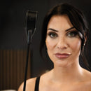 SEI MIO Rein in Desire Faux Leather Riding Crop held by a woman with striking makeup and an elegant look.