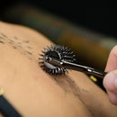 Person using the Sei Mio Wonder Wheel Sensory Pinwheel on skin for sensory stimulation.