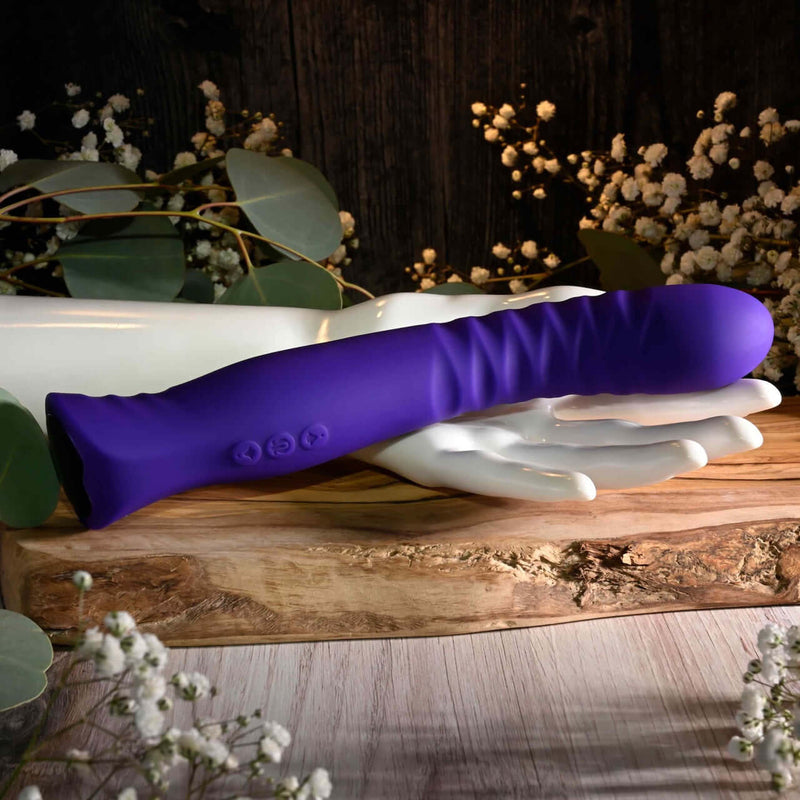 Purple Selopa Trixxxie Vibrator with textured flexible shaft and 7 vibration modes, displayed on a white hand sculpture.