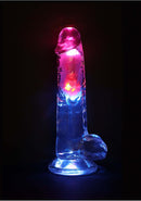 RealRock Vibrating Dildo 8 inch with Balls and Remote Control illuminated with vibrant colors on a dark background