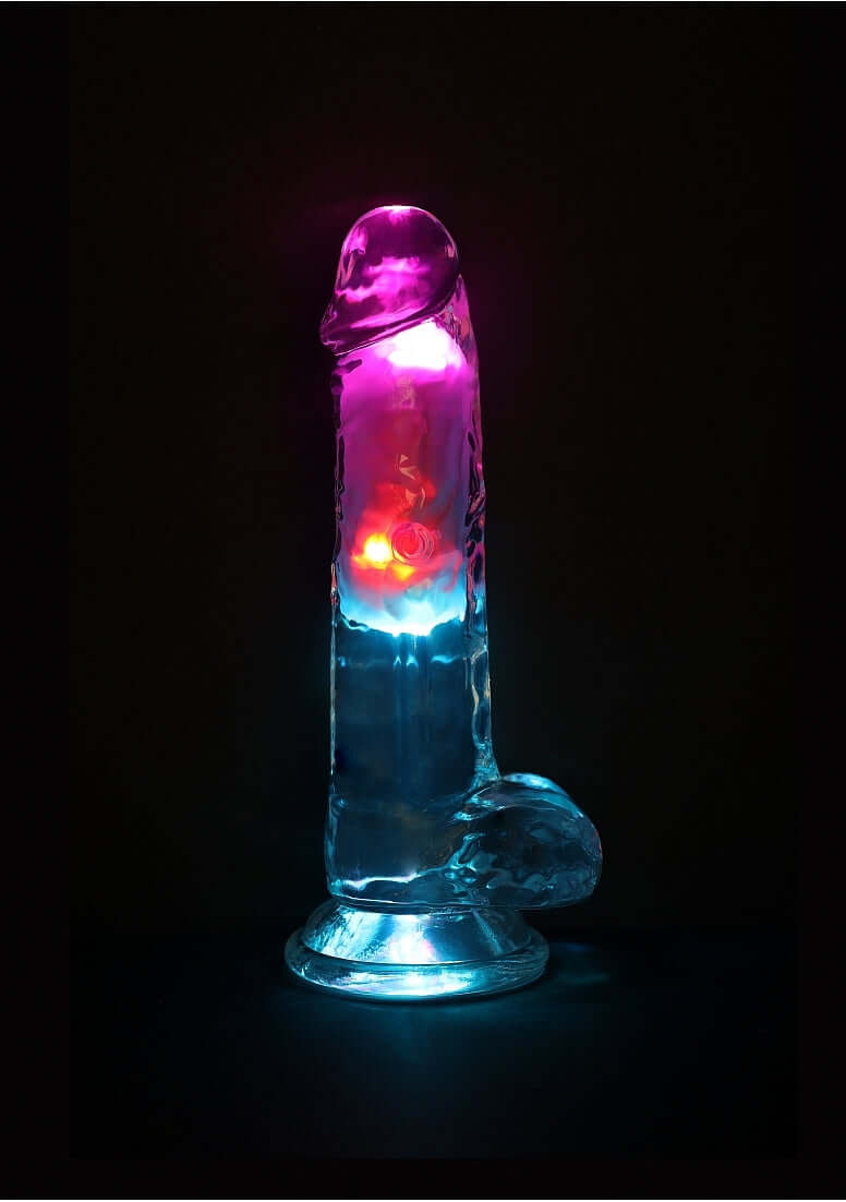 RealRock Vibrating Dildo 7 inch with Balls and Remote Control in glowing colors for enhanced pleasure.