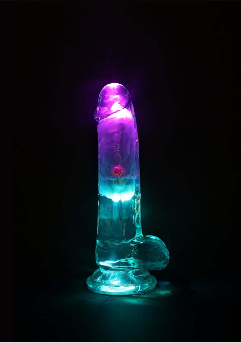 RealRock Vibrating Dildo 6 inch with Balls and Remote Control illuminated with vibrant blue and purple lights