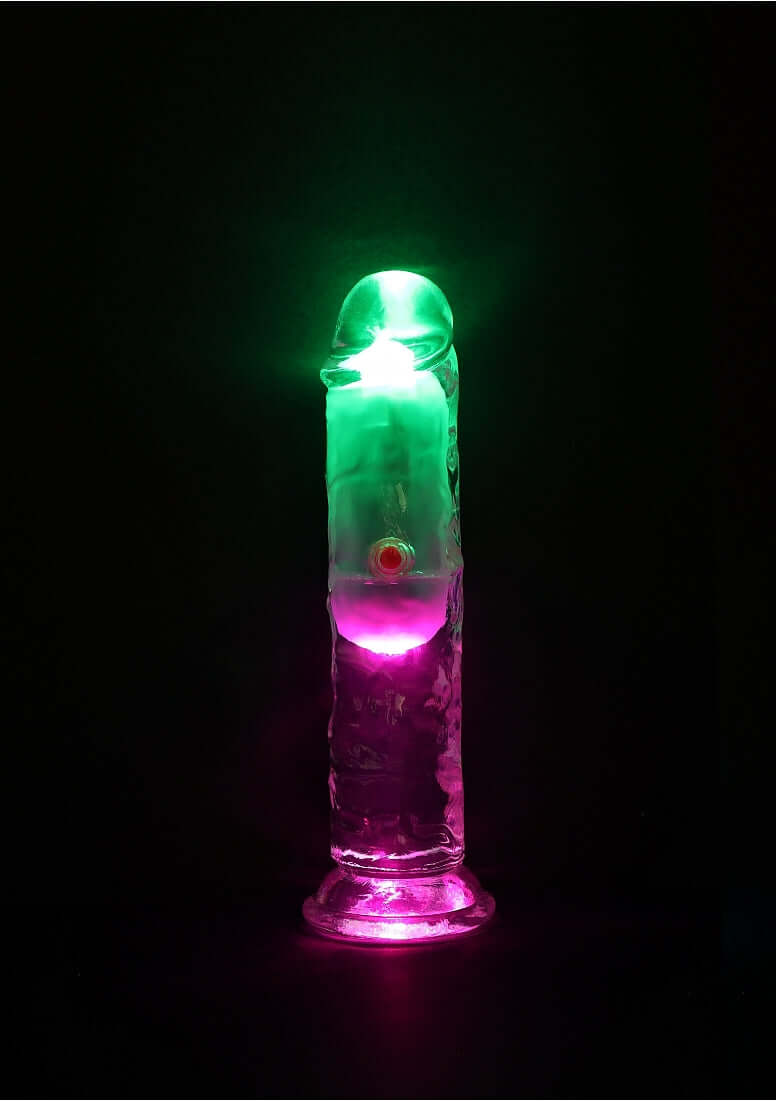RealRock Rechargeable Dildo with Remote Control 6 inches in illuminated colors, showcasing lifelike design and detail.