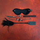 Sei Mio Fetish Feels Sensuous 5 Piece Sensation Kinky Kit accessories including a mask, flogger, and other restraint tools.