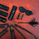 Sei Mio Complete Surrender The Ultimate Bed Tether Seduction Set accessories on a textured surface.