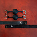 Sei Mio Silent Authority Progressive Interchangeable Ball Gag Set with black balls and adjustable straps on red background.