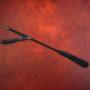 Sei Mio Spank You Very Much Sharp Sting Commanding Crop on a textured red background, showcasing precision design and sleek style.