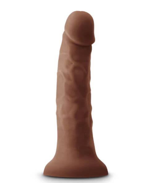 Chocolate silicone vibrating dildo with lifelike details and suction base for hands-free pleasure.