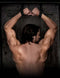 Man with muscular back bound in Command Bondage Door Cuffs, showcasing strength and restraint for BDSM enthusiasts.
