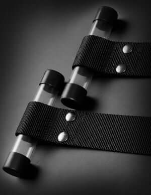 Close-up of Command Bondage Door Cuffs featuring high-strength acrylic tubes and industrial nylon straps for BDSM use.