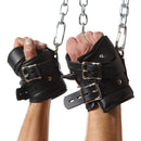 Strict Leather Premium Suspension Wrist Cuffs secured on hands, designed for comfortable restraint during bondage.