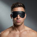 Strict Leather Padded Blindfold on a man, designed for sensory deprivation in bondage play.