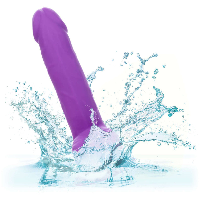 Purple Neon Silicone Studs 6 inch vibrator splashing in water, showcasing waterproof feature of CalExotics silicone pleasure product.