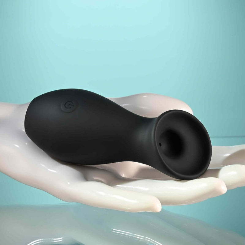 Metallic black Playboy The Jet Set Sucker clitoral suction toy with ergonomic design, displayed in a hand, ideal for on-the-go pleasure.