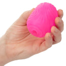 Hand holding Pop Sock!™ Textured Pink reversible stroker with soft, tight, and stretchy pink material for solo pleasure.