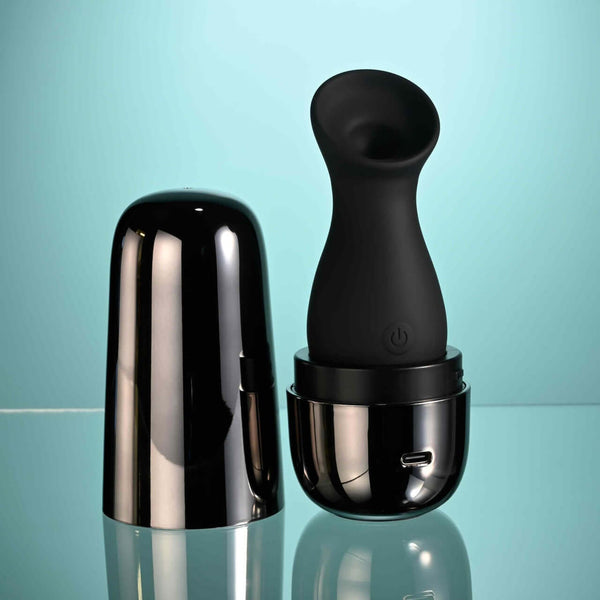 Playboy The Jet Set Sucker clitoral suction toy with sleek metallic black self-charging case for on-the-go pleasure.