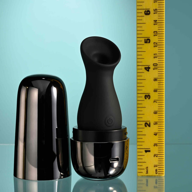 Playboy The Jet Set Sucker clitoral suction toy with metallic black charging case and ruler for size comparison