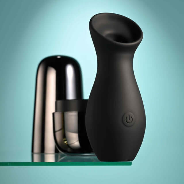 Playboy The Jet Set Sucker clitoral suction toy with sleek metallic black self-charging case for on-the-go pleasure.