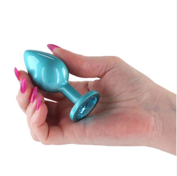 Rear Assets Chrome Anal Plug Medium Teal held in hand, showcasing its iridescent design and smooth finish.