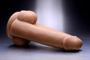 Tom Of Finland Dual Dicks 9.25 inches Dildo displayed on a sleek surface, showcasing its realistic design.
