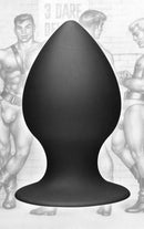 Tom Of Finland Anal Plug Extra Large Silicone Black against a backdrop of iconic erotic art.