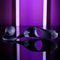 Zero Tolerance Tip to Tail Vibrating Plug & Penis Ring with flexible tail on reflective surface with purple background