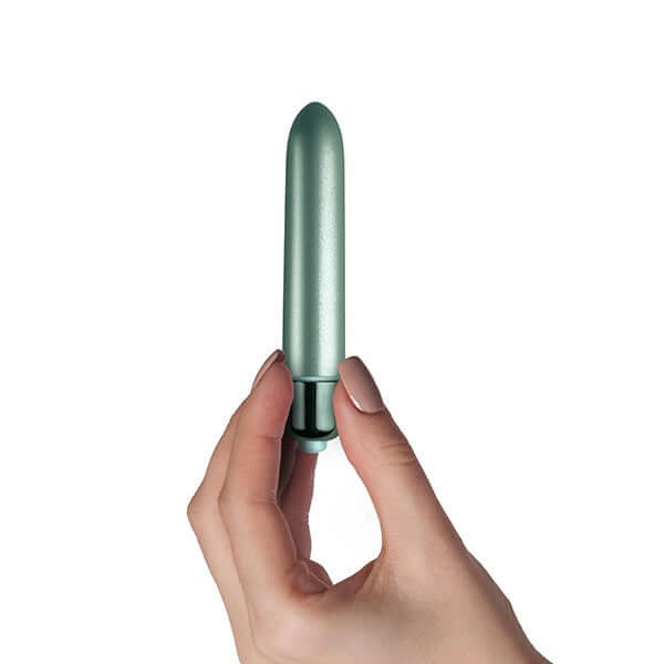 Hand holding Touch of Velvet Peacock Petals Bullet Vibrator from Rocks Off Toys, 3.54-inch compact and silky-smooth vibrator for precision stimulation