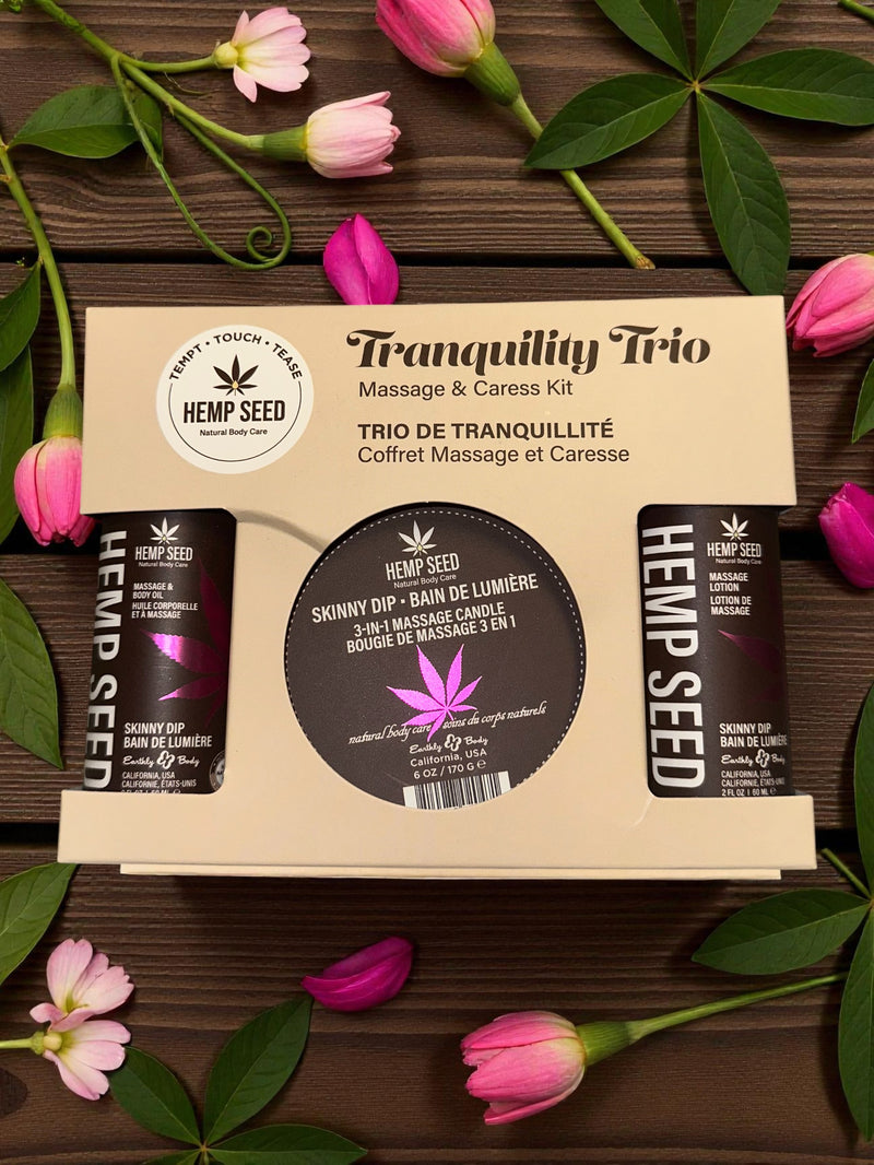 Earthly Body Hemp Seed Massage in a Box Gift Set Skinny Dip with tranquil flowers and massage kit products.