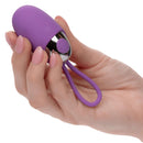 Hand holding the Turbo Buzz™ Bullet with Removable Silicone Sleeve in purple, showcasing its compact design and loop.