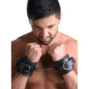 Strict Leather Padded Premium Locking Wrist Restraints worn by a man, showcasing comfort and secure restraint.