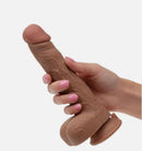 Working Stiff The Thrusting Jack Hammer Vibrating Dildo held in a hand, showcasing its realistic design and texture.