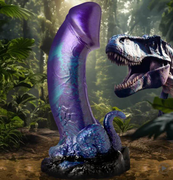 Creature Cocks Dino-Dick Dinosaur Silicone Dildo with suction cup in blue, black, purple, and teal hues in a prehistoric jungle setting.