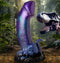 Creature Cocks Dino-Dick Dinosaur Silicone Dildo with suction cup in blue, black, purple, and teal hues in a prehistoric jungle setting.