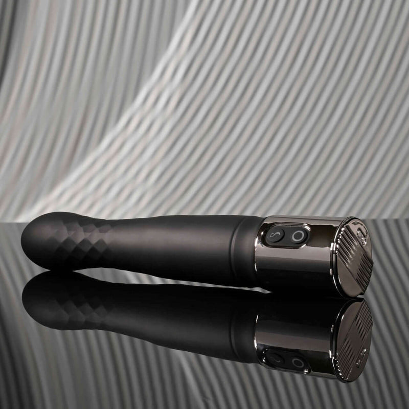 Playboy Pleasure Zone 10-speed vibrating and thrusting shaft with stylish charging case on reflective surface.