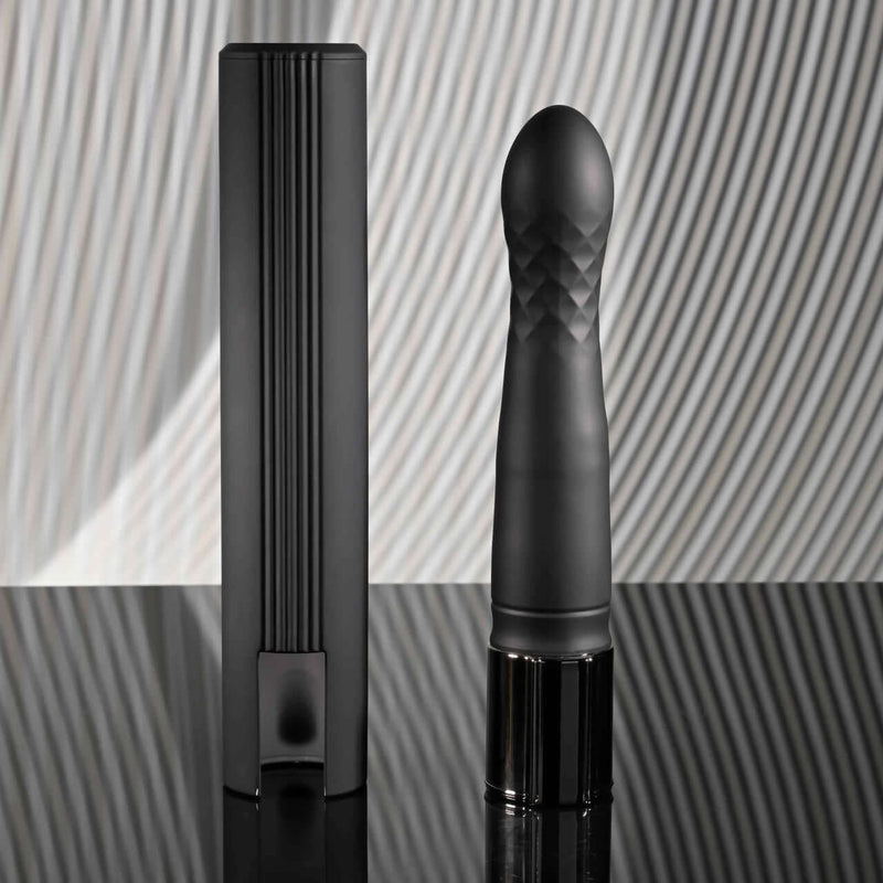Playboy Pleasure Zone 10-speed vibrating and thrusting shaft with stylish black charging case on reflective surface.