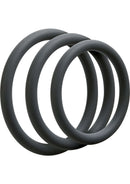 Three slate-colored silicone cock rings from the Optimale Thin Silicone C-Ring Set, designed for enhancing size, girth, and performance.