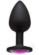 Black silicone butt plug with pink sparkling gem for intimate play