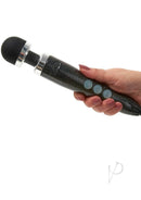 Woman holding Doxy Die Cast 3 Disco Black wand massager with silver trim and buttons.