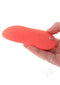 Hand holding We Vibe Touch X Crave Coral multi-purpose vibrator for clitoral stimulation and body massages