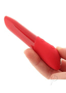 We-Vibe Tango X Cherry Red bullet vibrator held in hand displaying its sleek and powerful design for intense pleasure.