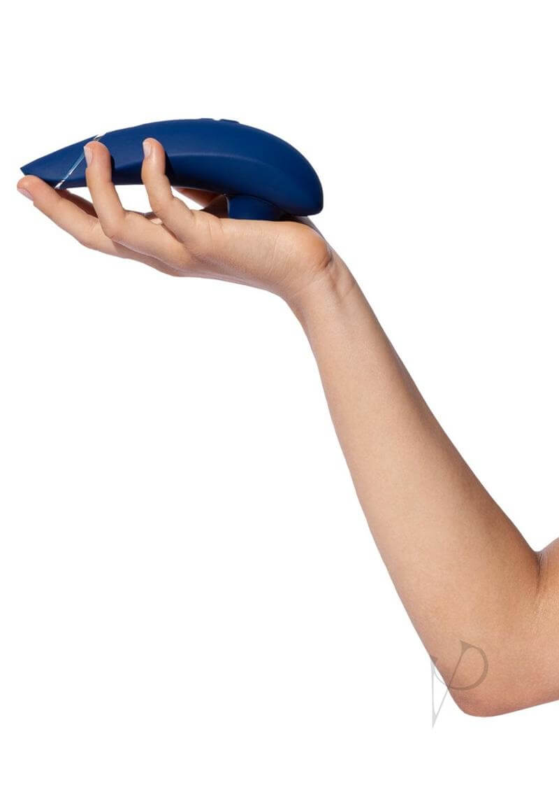 Woman holding Womanizer Premium 2 Blueberry luxury toy with 14 intensity levels, Smart Silence, and improved Autopilot feature