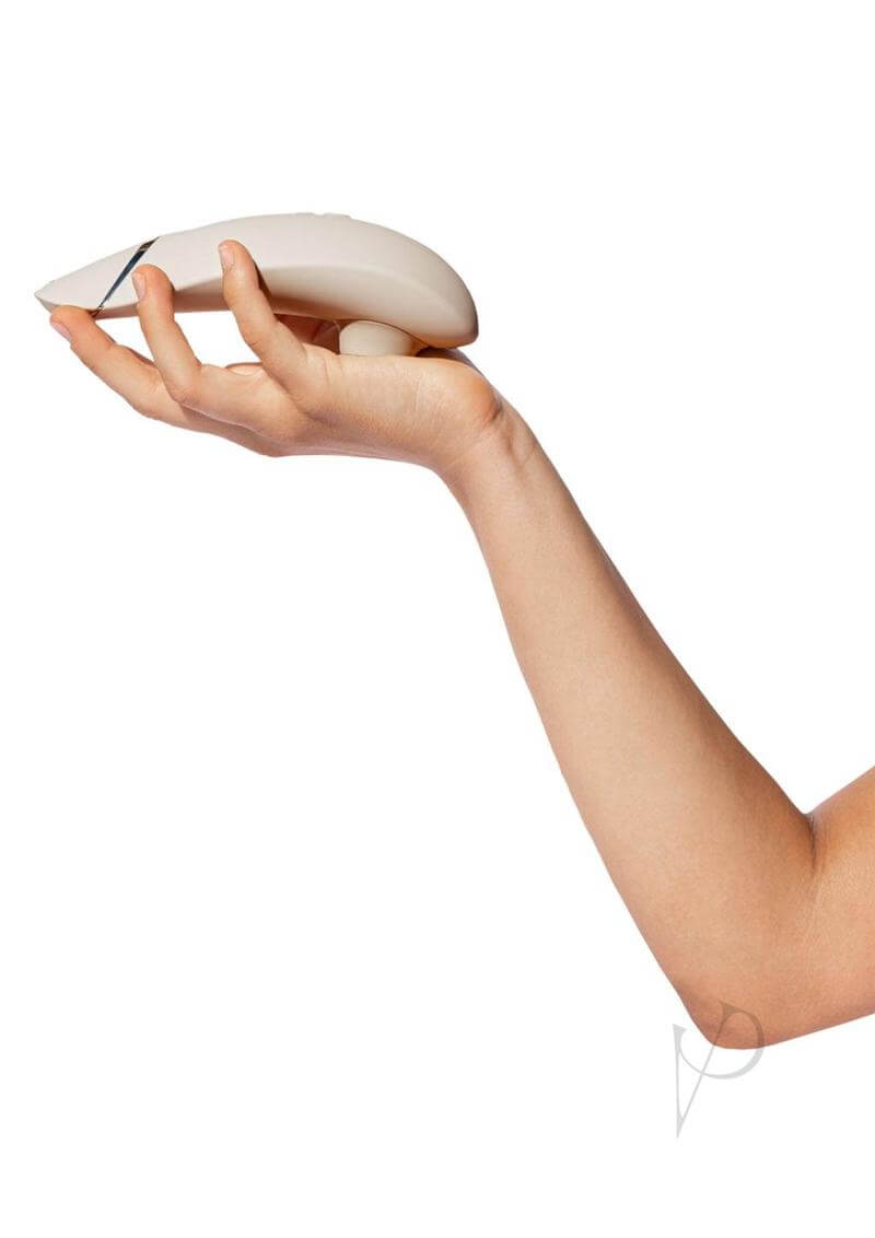 Woman holding Womanizer Premium 2 Rechargeable Clitoral Stimulator in Warm Gray with Pleasure Air Technology