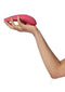 Hand holding Womanizer Premium 2 Raspberry luxury toy with innovative features and 14 intensity levels for a guided, sensory experience