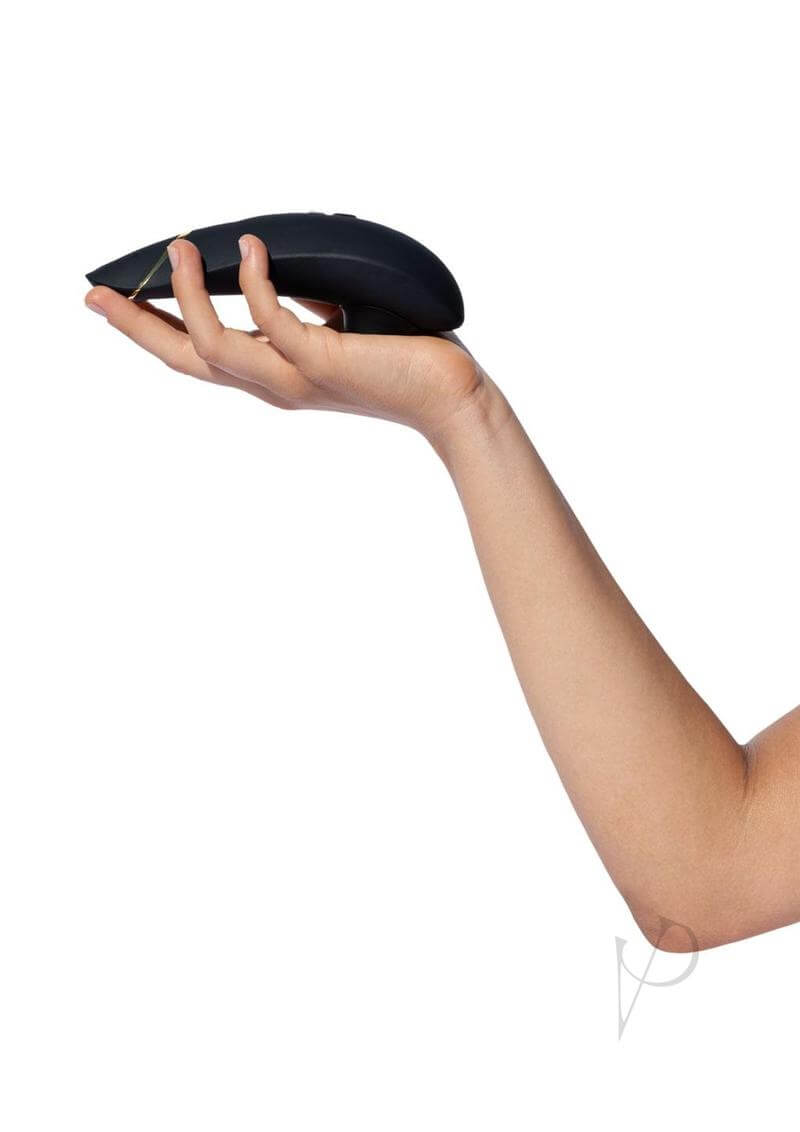 Hand holding Womanizer Premium 2 Rechargeable Clitoral Stimulator in Black with Pleasure Air Technology.