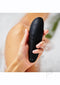 Woman holding the Womanizer Classic 2 Black in a bathtub showing the silky-smooth soft-touch surface.